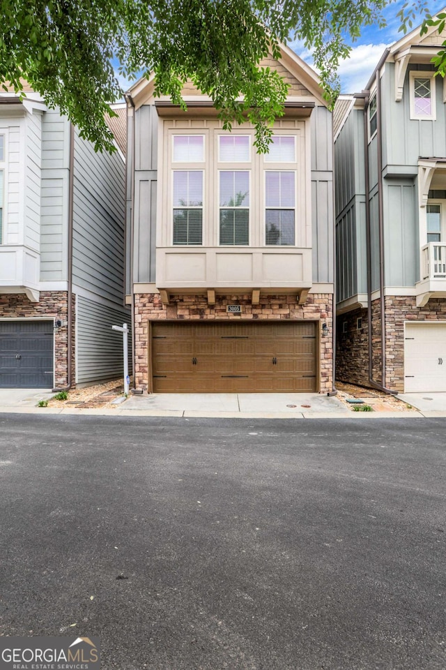 3005 Devoncroft St SE, Smyrna, GA 30080 - townhome / multi-family property with a garage, board and batten siding, and stone siding