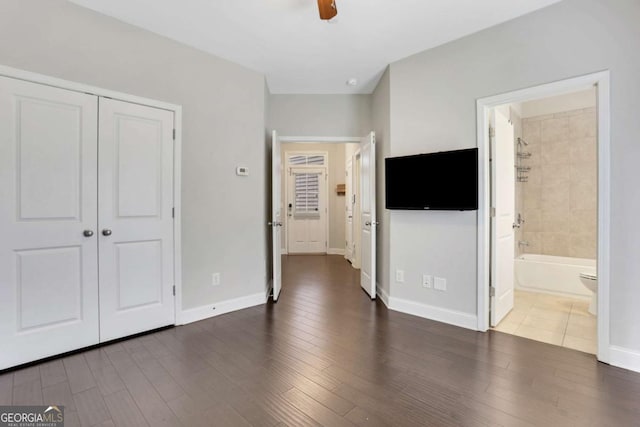 3005 Devoncroft St SE, Smyrna, GA 30080 - unfurnished bedroom featuring baseboards, dark wood-type flooring, a closet, and ensuite bathroom