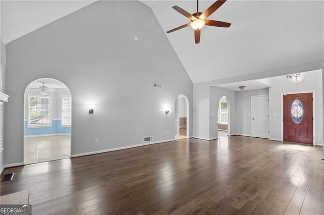 4956 Braeburn Trce NW, Acworth, GA 30102 - unfurnished living room with a ceiling fan, high vaulted ceiling, arched walkways, and wood finished floors