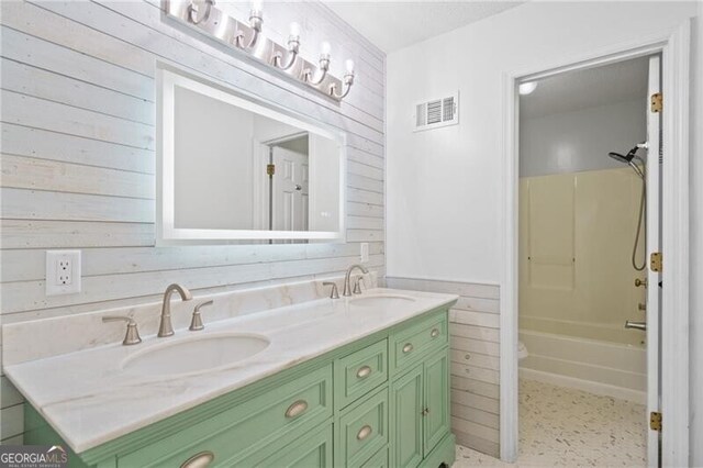 4956 Braeburn Trce NW, Acworth, GA 30102 - full bathroom with wood walls, double vanity, bathtub / shower combination, and a wainscoted wall