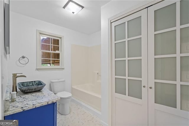 4956 Braeburn Trce NW, Acworth, GA 30102 - bathroom with toilet, vanity, shower / tub combination, and baseboards
