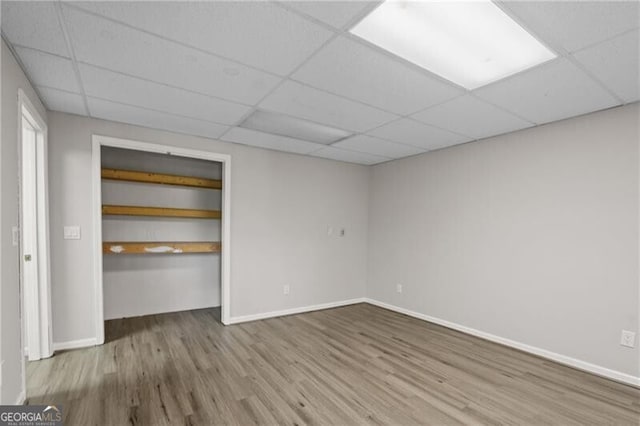 4956 Braeburn Trce NW, Acworth, GA 30102 - unfurnished bedroom featuring a paneled ceiling, wood finished floors, a closet, and baseboards
