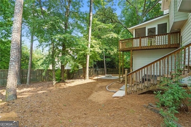 4956 Braeburn Trce NW, Acworth, GA 30102 - fenced backyard with stairs, a deck, and view of wooded area