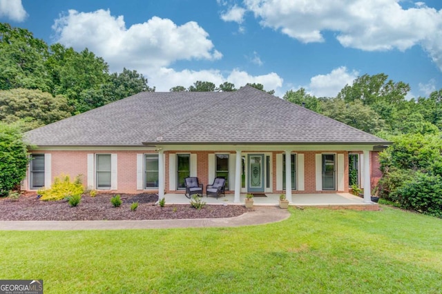 2005 Ashton Pointe Dr, Dacula, GA 30019 - view of front of property with a porch, a shingled roof, a front lawn, and brick siding