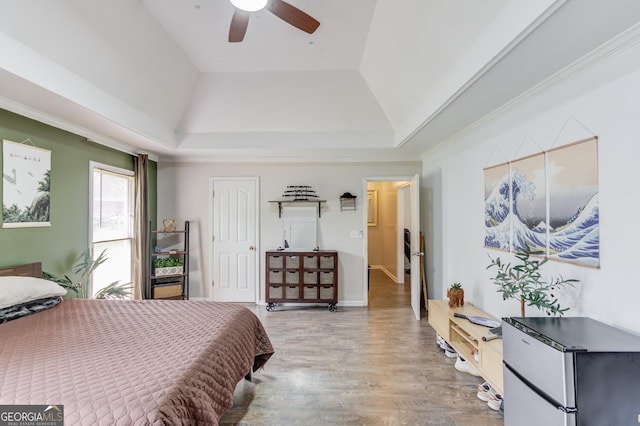 2005 Ashton Pointe Dr, Dacula, GA 30019 - bedroom featuring a raised ceiling, freestanding refrigerator, wood finished floors, ceiling fan, and a closet