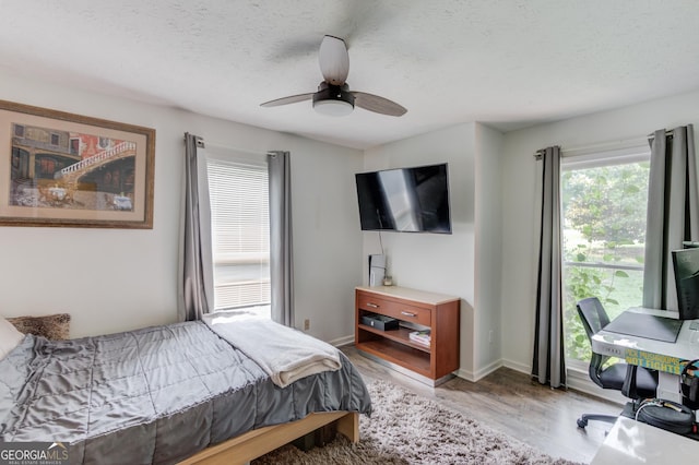 2005 Ashton Pointe Dr, Dacula, GA 30019 - bedroom featuring wood finished floors, a textured ceiling, ceiling fan, and baseboards