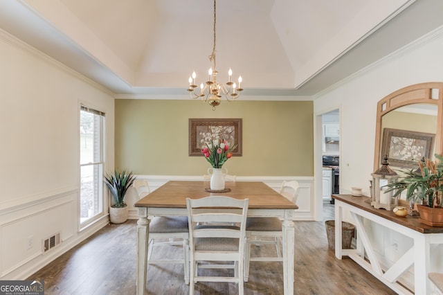 2005 Ashton Pointe Dr, Dacula, GA 30019 - dining space with a chandelier, wood finished floors, a wainscoted wall, a decorative wall, and ornamental molding