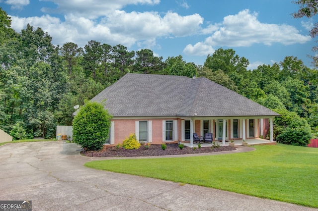 2005 Ashton Pointe Dr, Dacula, GA 30019 - view of front facade featuring a porch, roof with shingles, a front yard, concrete driveway, and brick siding