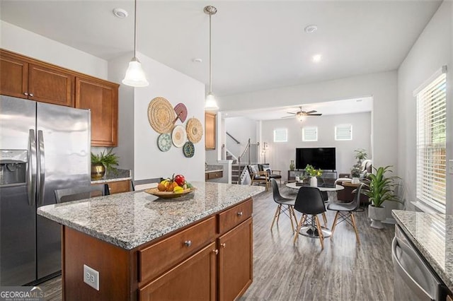 152 Malbone St SW, Cartersville, GA 30120 - kitchen with stainless steel appliances, dark wood-style flooring, a kitchen island, light stone counters, and hanging light fixtures