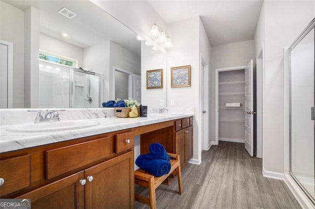 152 Malbone St SW, Cartersville, GA 30120 - full bathroom featuring a stall shower, wood finished floors, double vanity, and baseboards