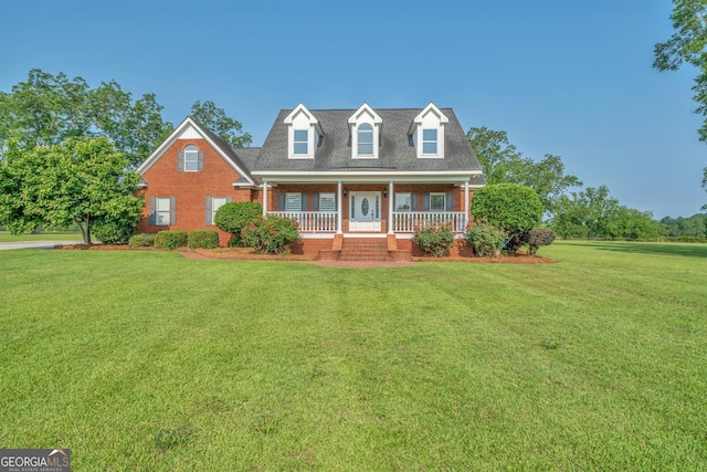 2717 Old Eastman Rd, Cadwell, GA 31009 - cape cod-style house with a porch, a front yard, and brick siding