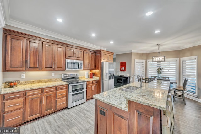 2717 Old Eastman Rd, Cadwell, GA 31009 - kitchen with appliances with stainless steel finishes, a sink, light wood-style floors, crown molding, and pendant lighting