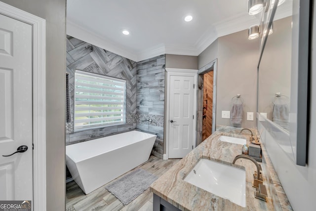 2717 Old Eastman Rd, Cadwell, GA 31009 - bathroom with ornamental molding, a freestanding bath, double vanity, tile walls, and recessed lighting