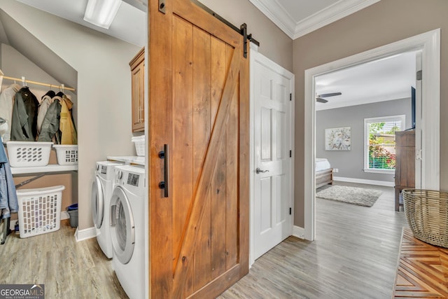 2717 Old Eastman Rd, Cadwell, GA 31009 - laundry room with cabinet space, washing machine and dryer, a barn door, ornamental molding, and baseboards
