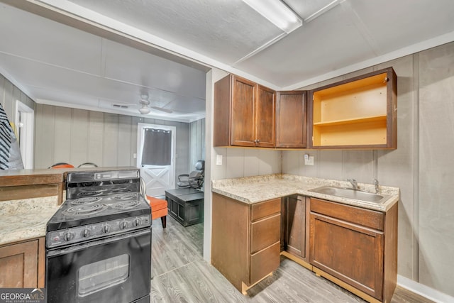 2717 Old Eastman Rd, Cadwell, GA 31009 - kitchen featuring electric stove, light wood finished floors, a sink, open shelves, and brown cabinetry