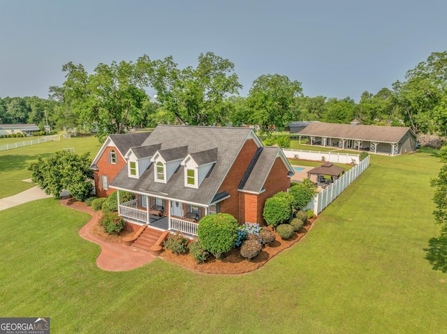 2717 Old Eastman Rd, Cadwell, GA 31009 - cape cod-style house featuring a porch, view of wooded area, and roof with shingles