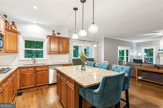 2220 Cape Courage Way, Suwanee, GA 30024 - kitchen featuring stainless steel appliances, a kitchen breakfast bar, open floor plan, a center island, and dark wood-type flooring