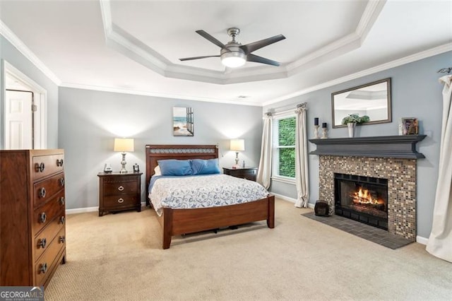 2220 Cape Courage Way, Suwanee, GA 30024 - bedroom featuring light carpet, a tray ceiling, crown molding, a tile fireplace, and ceiling fan