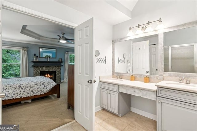 2220 Cape Courage Way, Suwanee, GA 30024 - ensuite bathroom with double vanity, a stall shower, a lit fireplace, and a ceiling fan