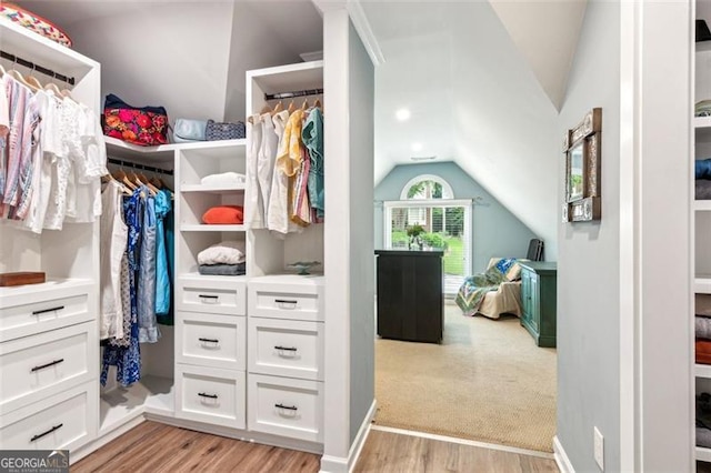 2220 Cape Courage Way, Suwanee, GA 30024 - spacious closet featuring lofted ceiling and light wood-style floors