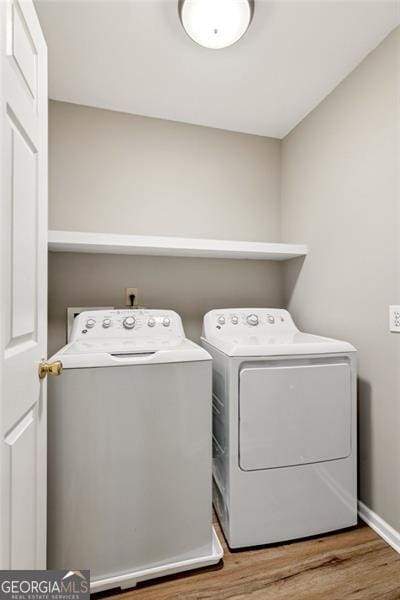 2220 Cape Courage Way, Suwanee, GA 30024 - laundry room featuring independent washer and dryer, wood finished floors, and baseboards