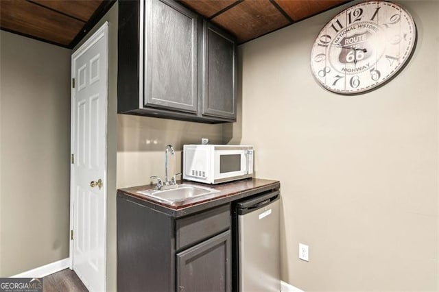 2220 Cape Courage Way, Suwanee, GA 30024 - kitchen with white microwave, dishwasher, a sink, baseboards, and gray cabinets