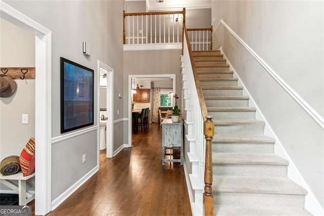 2220 Cape Courage Way, Suwanee, GA 30024 - entryway with stairs, wood finished floors, a towering ceiling, and baseboards