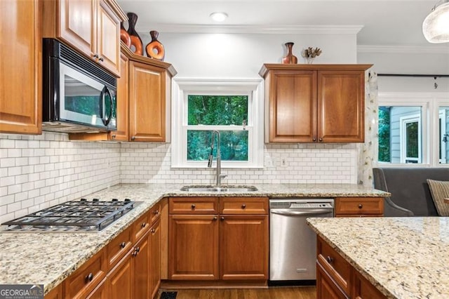 2220 Cape Courage Way, Suwanee, GA 30024 - kitchen featuring stainless steel appliances, a sink, crown molding, light stone countertops, and plenty of natural light