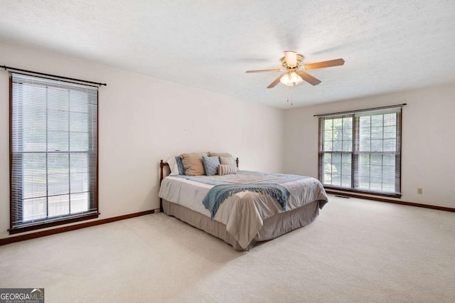 272 Creek Ct SW, Marietta, GA 30064 - carpeted bedroom with baseboards, a ceiling fan, and a textured ceiling