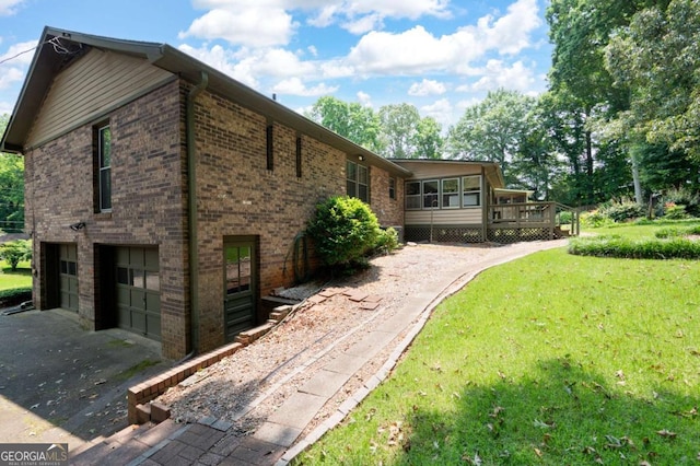 272 Creek Ct SW, Marietta, GA 30064 - view of property exterior with an attached garage, brick siding, asphalt driveway, and a wooden deck