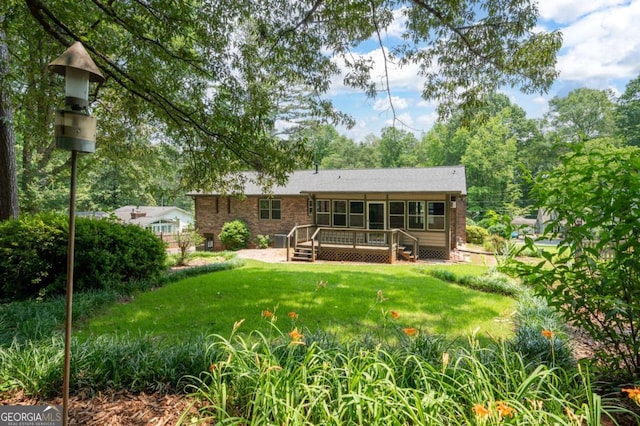 272 Creek Ct SW, Marietta, GA 30064 - back of property featuring a deck, a sunroom, and a yard