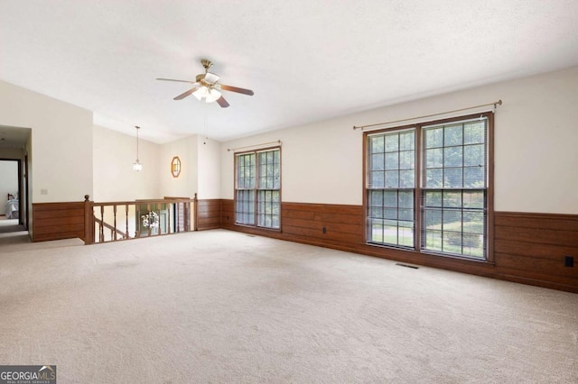 272 Creek Ct SW, Marietta, GA 30064 - carpeted empty room with wainscoting, ceiling fan, healthy amount of natural light, and wood walls