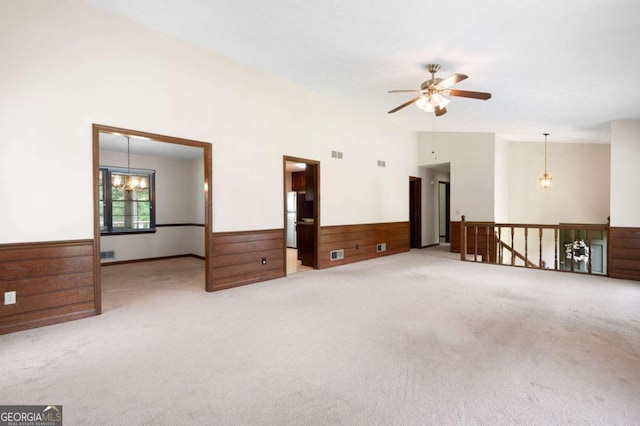 272 Creek Ct SW, Marietta, GA 30064 - carpeted empty room with a wainscoted wall, a ceiling fan, a chandelier, vaulted ceiling, and wooden walls