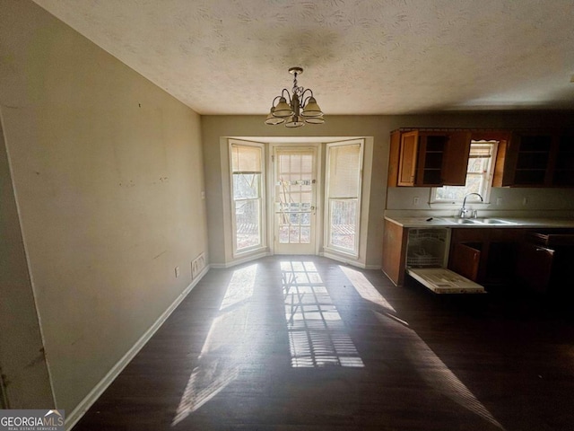 43 Oak Landing Cir, Douglasville, GA 30134 - unfurnished dining area featuring a chandelier, a textured ceiling, and dark wood-type flooring