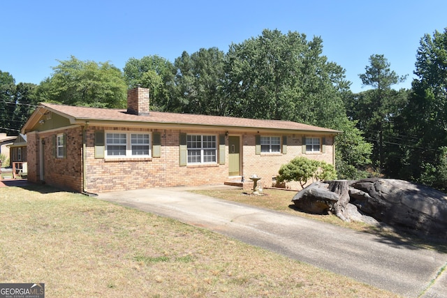3400 Scott Dr, Austell, GA 30106 - ranch-style house with a chimney, a front yard, and brick siding