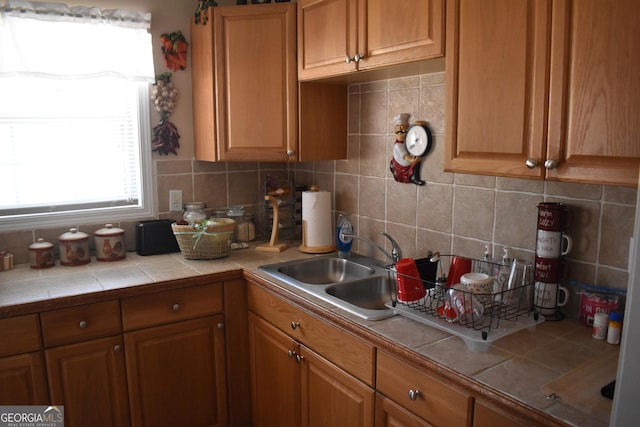 3400 Scott Dr, Austell, GA 30106 - kitchen featuring backsplash, brown cabinets, and tile counters
