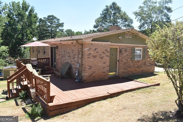3400 Scott Dr, Austell, GA 30106 - back of house featuring brick siding, a deck, a chimney, and a lawn