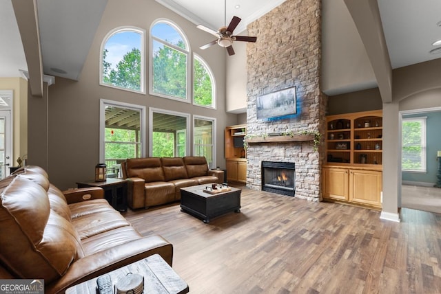 149 Highland Rd S, Dahlonega, GA 30533 - living area featuring a fireplace, ceiling fan, light wood-style floors, a high ceiling, and baseboards