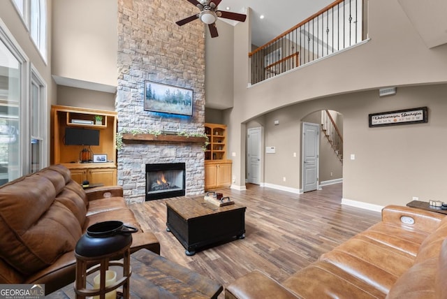 149 Highland Rd S, Dahlonega, GA 30533 - living room with a ceiling fan, a high ceiling, a fireplace, stairs, and wood finished floors