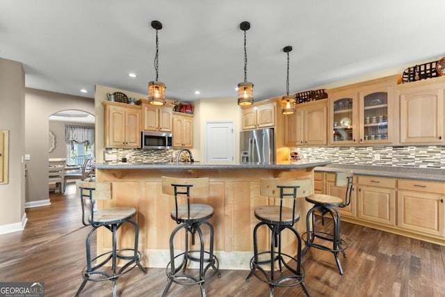 149 Highland Rd S, Dahlonega, GA 30533 - kitchen featuring appliances with stainless steel finishes, light brown cabinetry, arched walkways, glass insert cabinets, and backsplash
