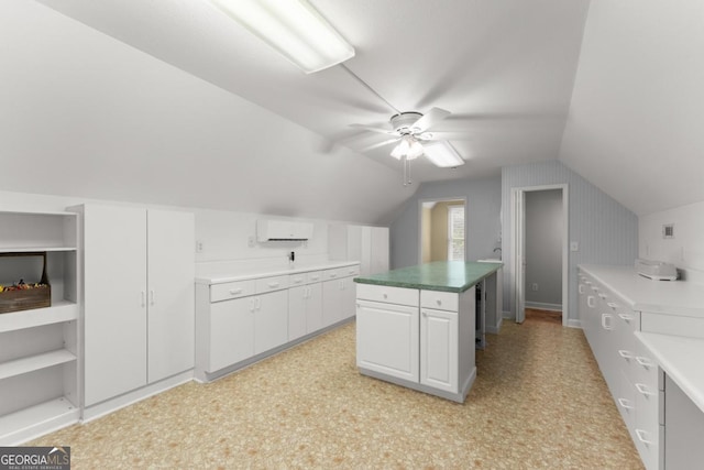 149 Highland Rd S, Dahlonega, GA 30533 - kitchen featuring an AC wall unit, white cabinetry, lofted ceiling, ceiling fan, and a center island