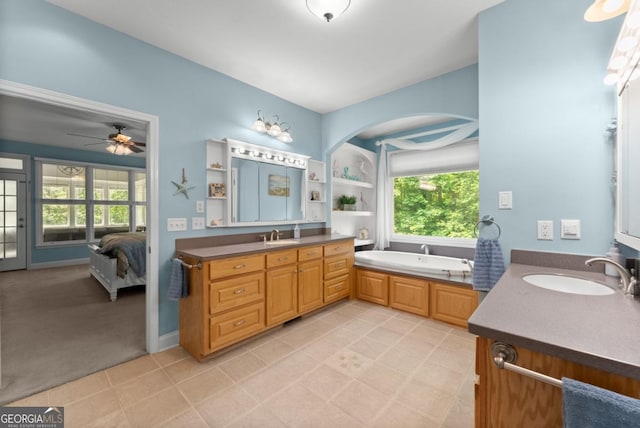 149 Highland Rd S, Dahlonega, GA 30533 - full bathroom with two vanities, a garden tub, a ceiling fan, connected bathroom, and tile patterned flooring