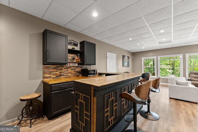 149 Highland Rd S, Dahlonega, GA 30533 - bar area with light wood-style flooring, a paneled ceiling, backsplash, recessed lighting, and baseboards