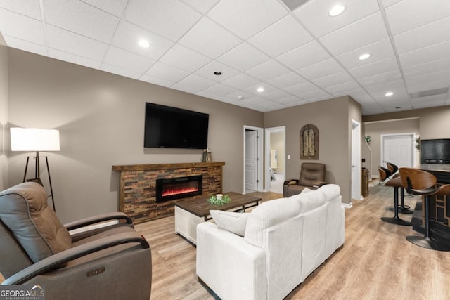 149 Highland Rd S, Dahlonega, GA 30533 - living room featuring light wood finished floors, baseboards, a glass covered fireplace, recessed lighting, and a drop ceiling
