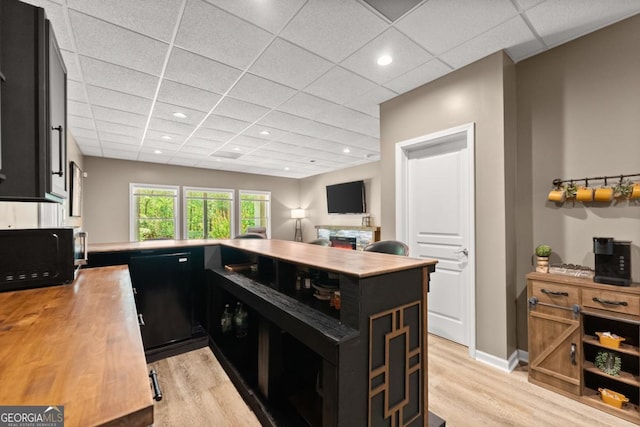 149 Highland Rd S, Dahlonega, GA 30533 - kitchen with black appliances, dark cabinets, light wood-style flooring, wooden counters, and a drop ceiling