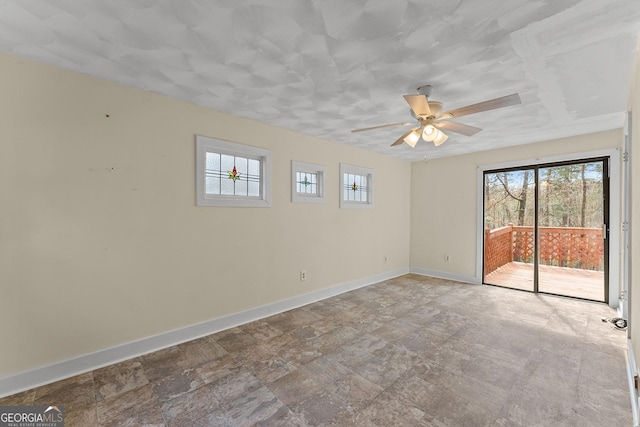 405 Cedar Hollow Rd Unit 2, Cleveland, GA 30528 - unfurnished room with baseboards, a ceiling fan, and stone finish flooring