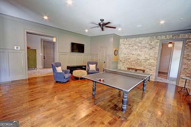 1178 Chambord Way NE, Brookhaven, GA 30319 - game room with a decorative wall, ceiling fan, ornamental molding, wood finished floors, and wainscoting