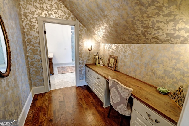 1178 Chambord Way NE, Brookhaven, GA 30319 - office space featuring vaulted ceiling, built in desk, dark wood-style floors, wallpapered walls, and baseboards