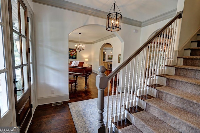 1178 Chambord Way NE, Brookhaven, GA 30319 - entryway featuring a chandelier, arched walkways, wood finished floors, stairway, and crown molding