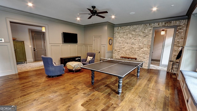 1178 Chambord Way NE, Brookhaven, GA 30319 - playroom with a decorative wall, ceiling fan, ornamental molding, wood finished floors, and a wainscoted wall